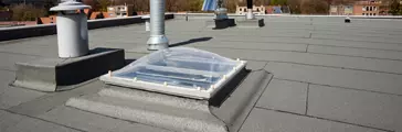 Inox Chimney on the flat roof in the city.