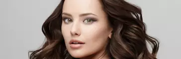 Young woman with curled hair and bare back